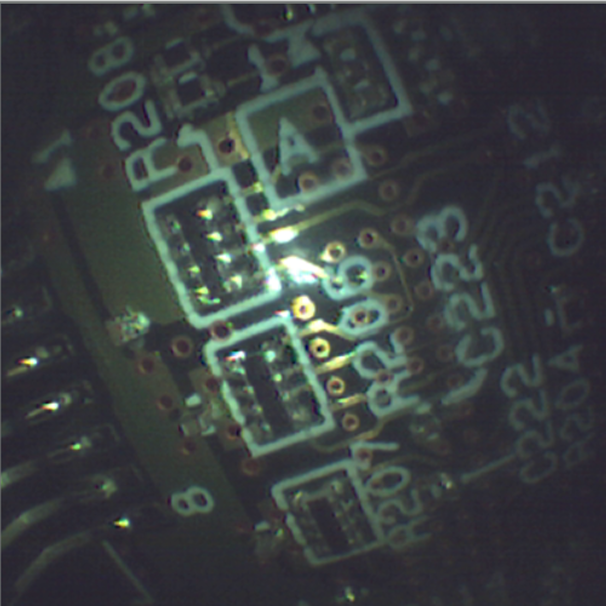 Magnified view of mounted components on a printed circuit board captured by the endoscope camera